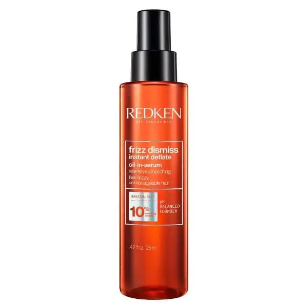 Redken Frizz Dismiss Instant Deflate Oil-in-Serum in orange Flasche mit schwarzem Pumpenarm